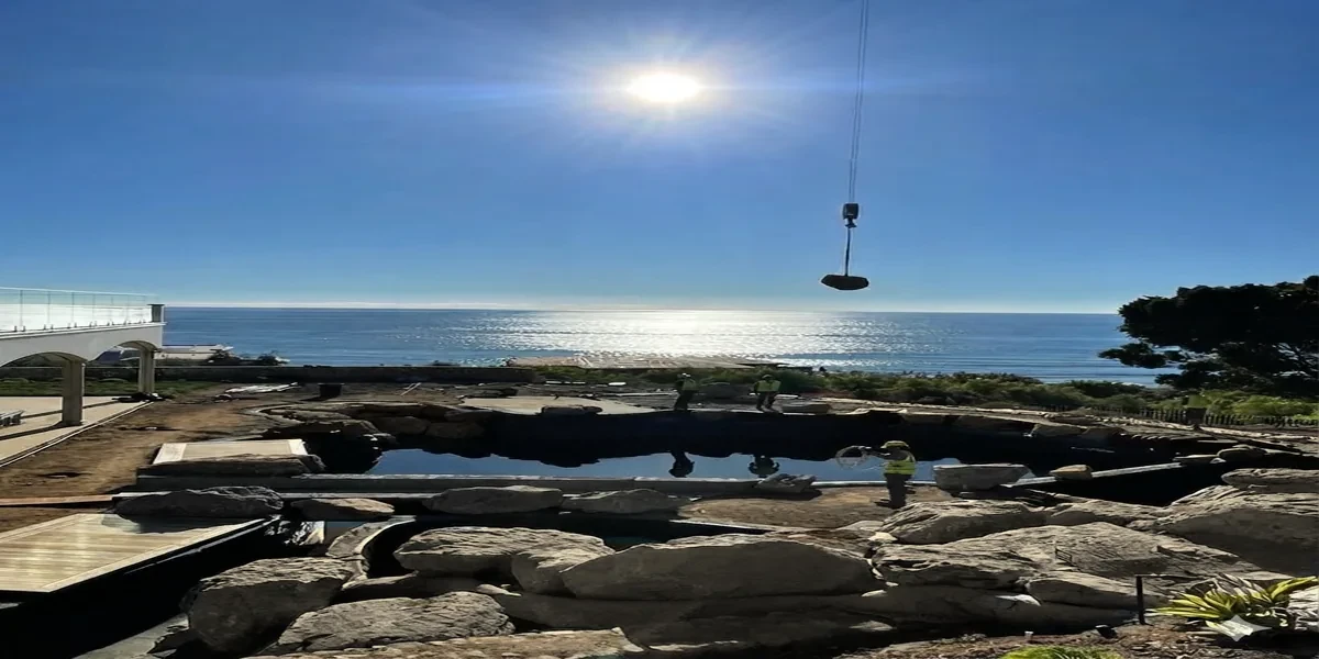 Ocean-view infinity edge gunite pool with travertine deck in Malibu California